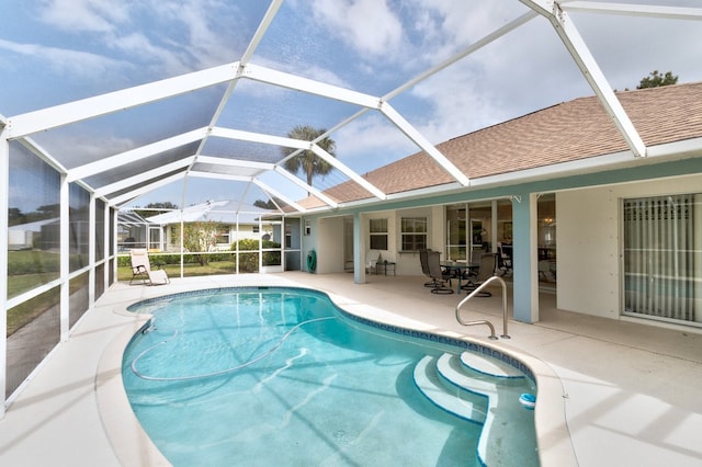 view of swimming pool featuring a lanai and a patio