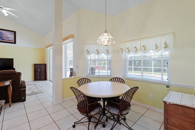 dining room featuring high vaulted ceiling, light tile patterned floors, and ceiling fan with notable chandelier