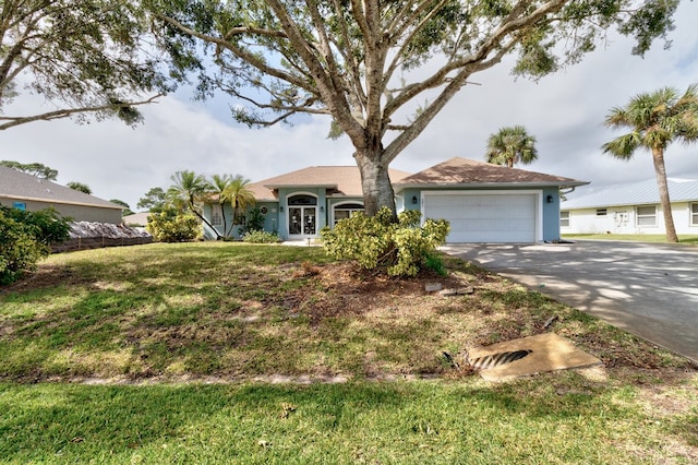 ranch-style home featuring a garage and a front yard