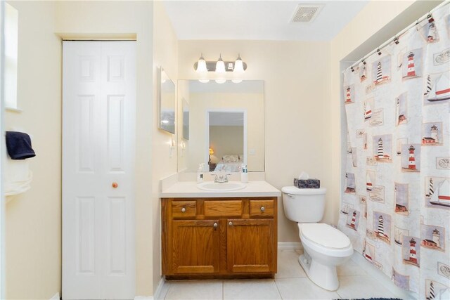 bathroom with a shower with curtain, tile patterned flooring, vanity, toilet, and visible vents