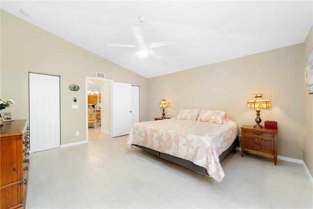 bedroom with baseboards, lofted ceiling, visible vents, and a ceiling fan