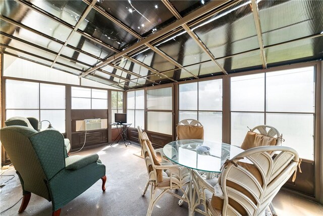 sunroom with carpet flooring, lofted ceiling, and cooling unit