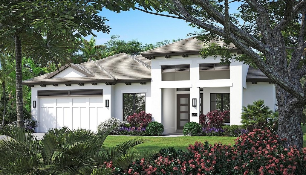 view of front of home featuring a front lawn and a garage