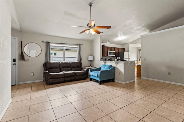 unfurnished living room featuring lofted ceiling, light tile patterned floors, and ceiling fan