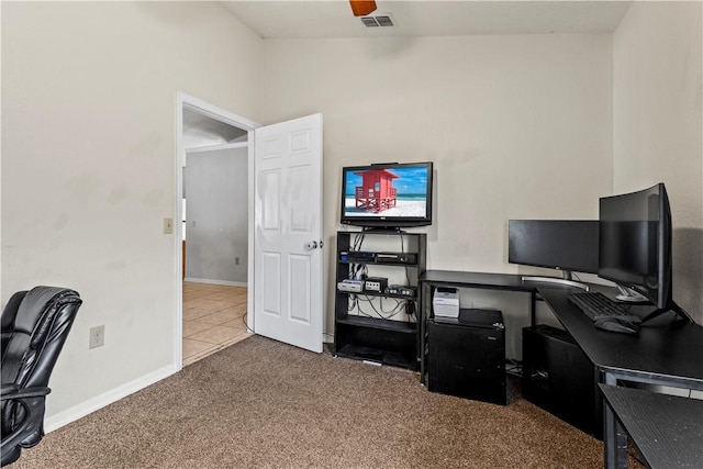 carpeted home office featuring ceiling fan