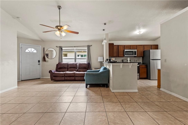 kitchen featuring pendant lighting, appliances with stainless steel finishes, a breakfast bar, and light tile patterned floors