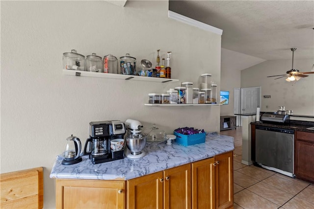 bar with lofted ceiling, stainless steel dishwasher, ceiling fan, and light tile patterned flooring