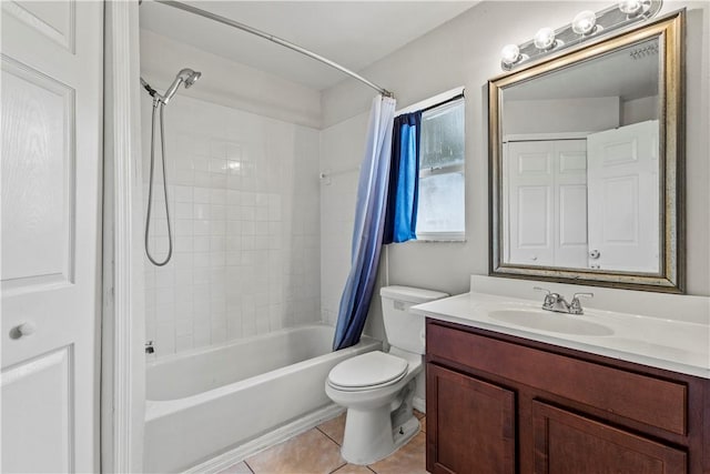 full bathroom with vanity, tile patterned floors, toilet, and shower / bath combo with shower curtain