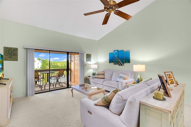 living room with ceiling fan, high vaulted ceiling, and light colored carpet