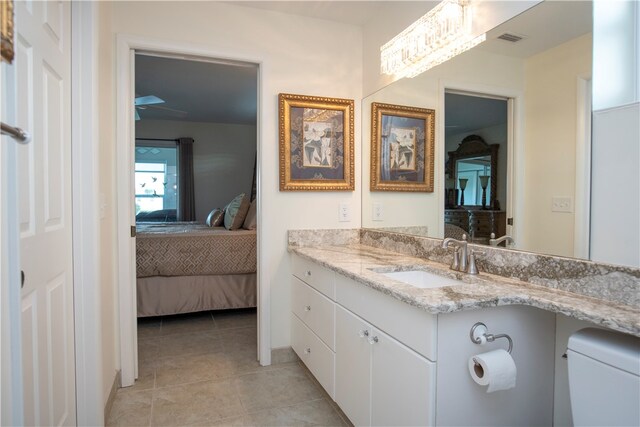 bathroom with tile patterned flooring, vanity, and toilet