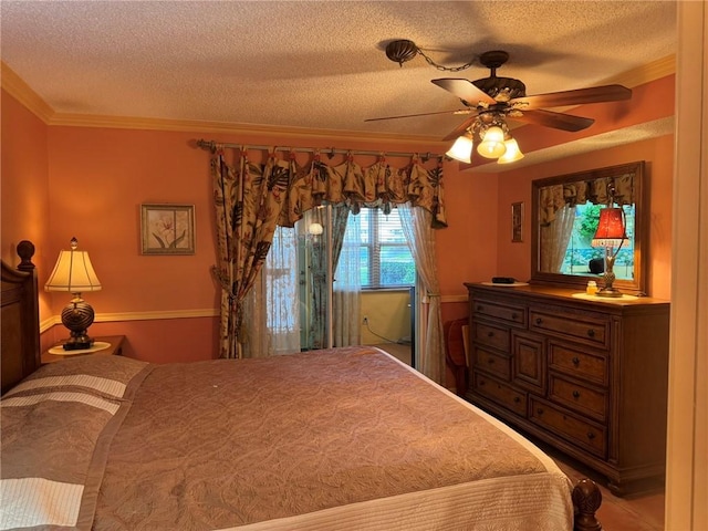 bedroom featuring a textured ceiling, a ceiling fan, and crown molding