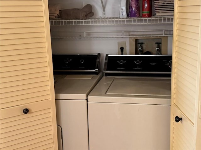 clothes washing area featuring laundry area and washing machine and clothes dryer