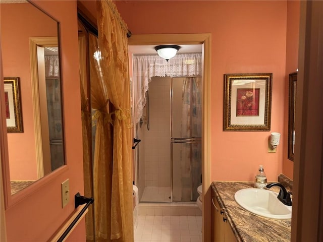 full bathroom featuring toilet, a shower stall, tile patterned flooring, and vanity