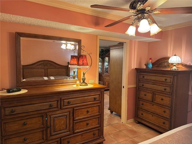 bedroom featuring light tile patterned flooring, a ceiling fan, and crown molding