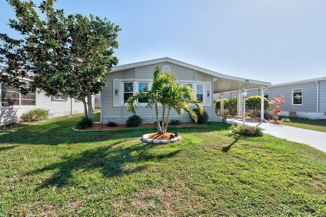 view of front of house featuring a front lawn and a carport