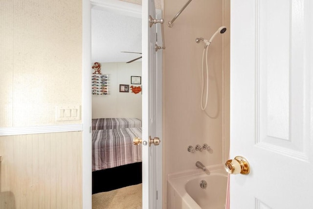 bathroom with shower / bath combination and a textured ceiling