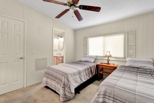 carpeted bedroom with a textured ceiling, ensuite bath, ceiling fan, and lofted ceiling