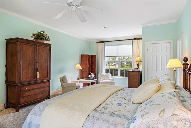 carpeted bedroom with ceiling fan and ornamental molding