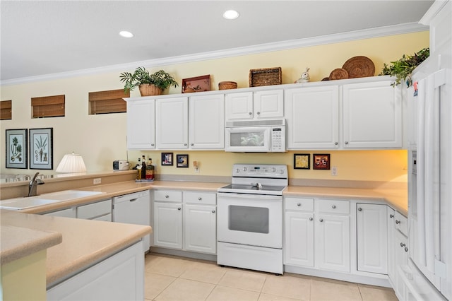 kitchen featuring white appliances, light tile patterned floors, ornamental molding, and white cabinets