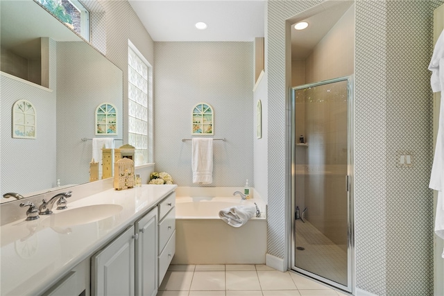 bathroom featuring vanity, independent shower and bath, and tile patterned flooring