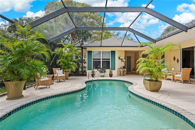 view of swimming pool featuring glass enclosure and a patio area