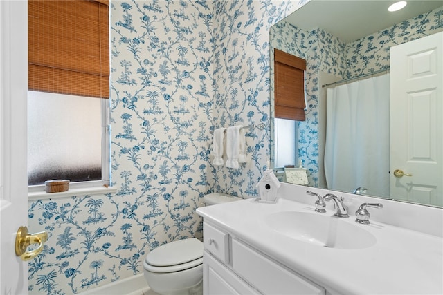 bathroom featuring vanity and toilet