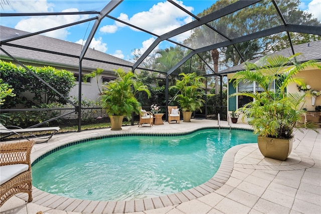 view of swimming pool featuring a patio area and a lanai