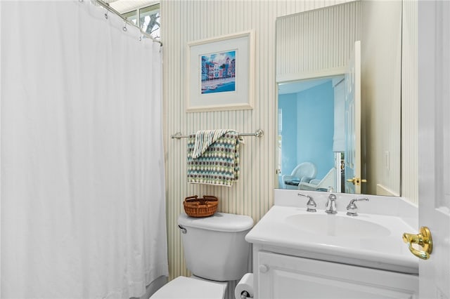 bathroom featuring vanity and toilet