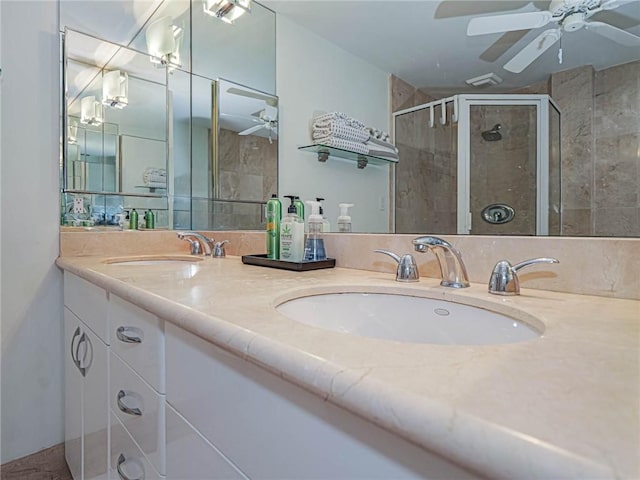 bathroom with a shower with door, vanity, and ceiling fan