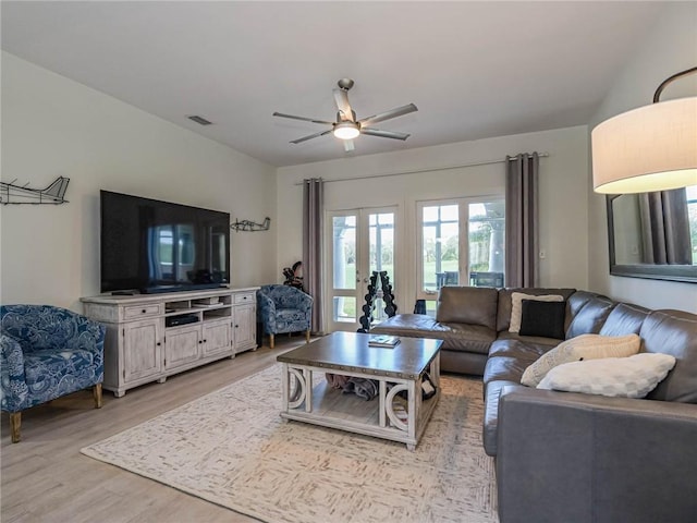 living room featuring light hardwood / wood-style floors and ceiling fan