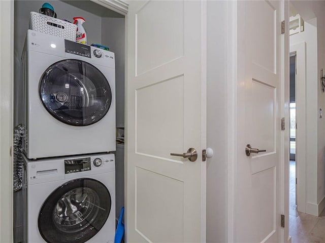 laundry room featuring stacked washer and clothes dryer