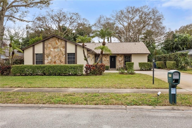 2821 21st Pl, Vero Beach, FL 32960 - view of front of house featuring stone siding, stucco siding, and a front yard