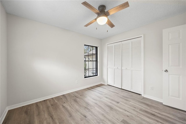2821 21st Pl, Vero Beach, FL 32960 - unfurnished bedroom featuring wood finished floors, a closet, baseboards, and ceiling fan
