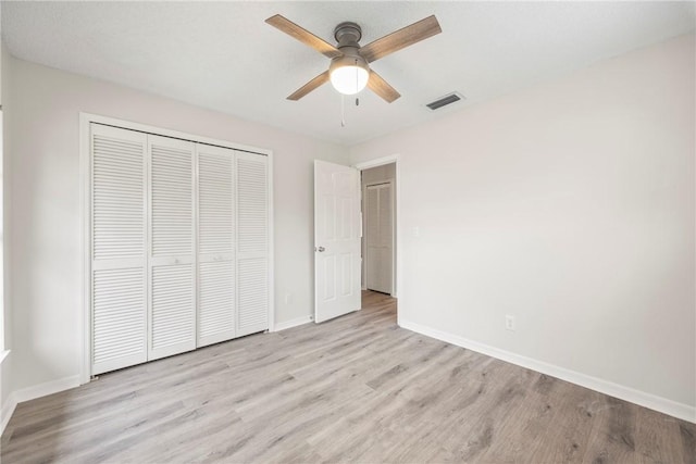 2821 21st Pl, Vero Beach, FL 32960 - unfurnished bedroom featuring light wood finished floors, a closet, and baseboards