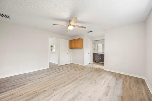 2821 21st Pl, Vero Beach, FL 32960 - unfurnished living room featuring a ceiling fan, light wood-style floors, and baseboards