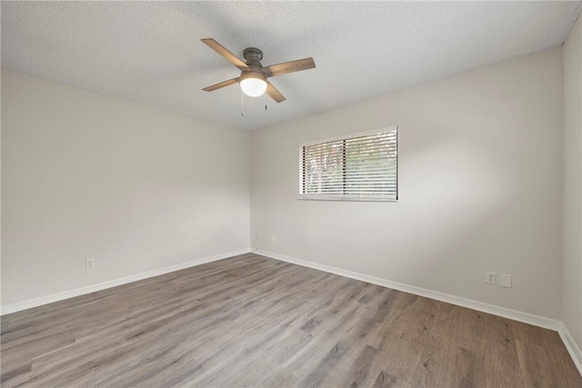 2821 21st Pl, Vero Beach, FL 32960 - unfurnished room featuring ceiling fan, wood finished floors, baseboards, and a textured ceiling