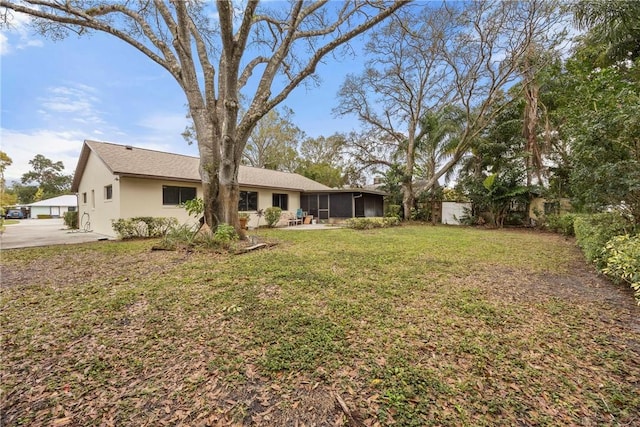 2821 21st Pl, Vero Beach, FL 32960 - view of yard with a sunroom and concrete driveway