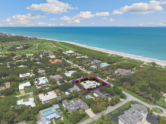 birds eye view of property with a beach view and a water view