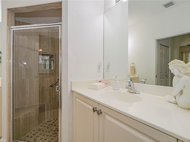 bathroom with vanity and a shower with shower door