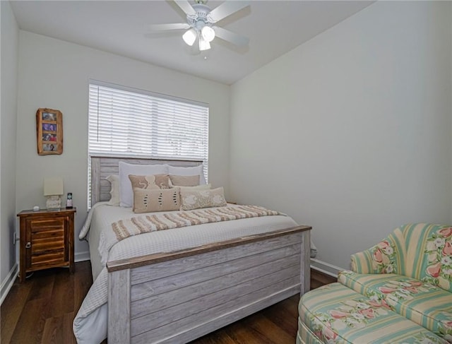 bedroom with dark hardwood / wood-style flooring and ceiling fan