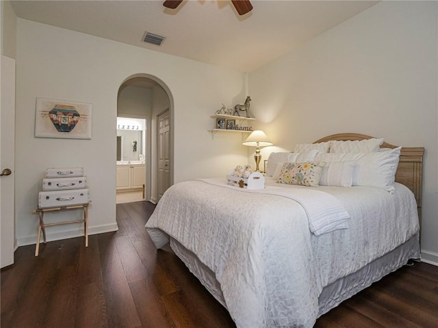 bedroom featuring dark hardwood / wood-style floors, ceiling fan, and ensuite bathroom