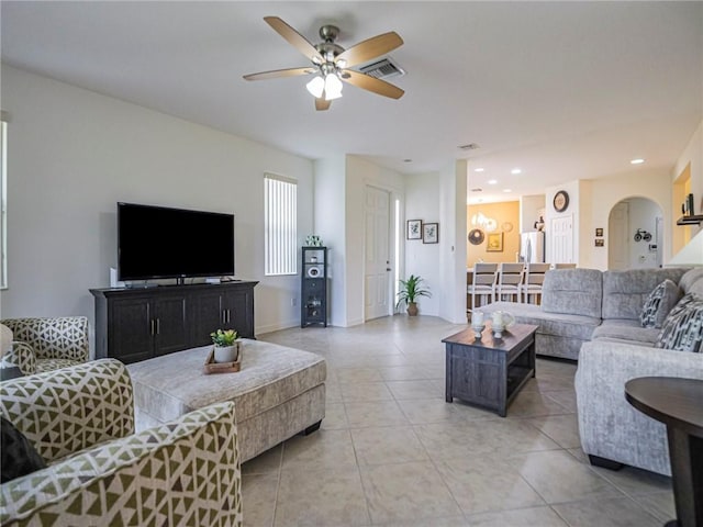 tiled living room with ceiling fan