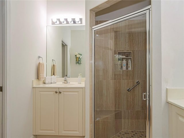 bathroom with vanity and a shower with shower door