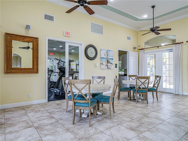 tiled dining area featuring crown molding, french doors, and ceiling fan