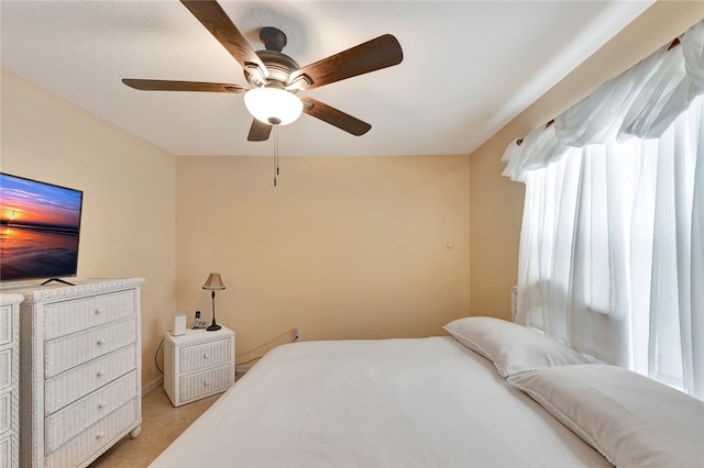 carpeted bedroom with multiple windows and ceiling fan