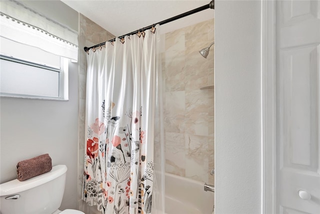 bathroom with toilet and shower / bath combo with shower curtain