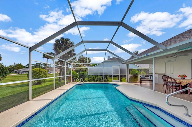 view of swimming pool featuring a lawn, glass enclosure, and a patio area