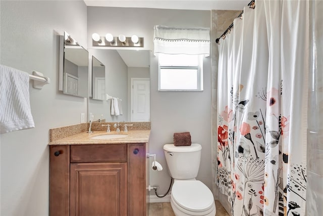 bathroom featuring curtained shower, vanity, and toilet