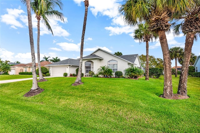 ranch-style home with a garage and a front lawn