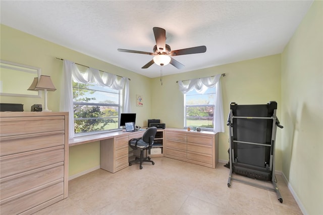 office area with a textured ceiling and ceiling fan